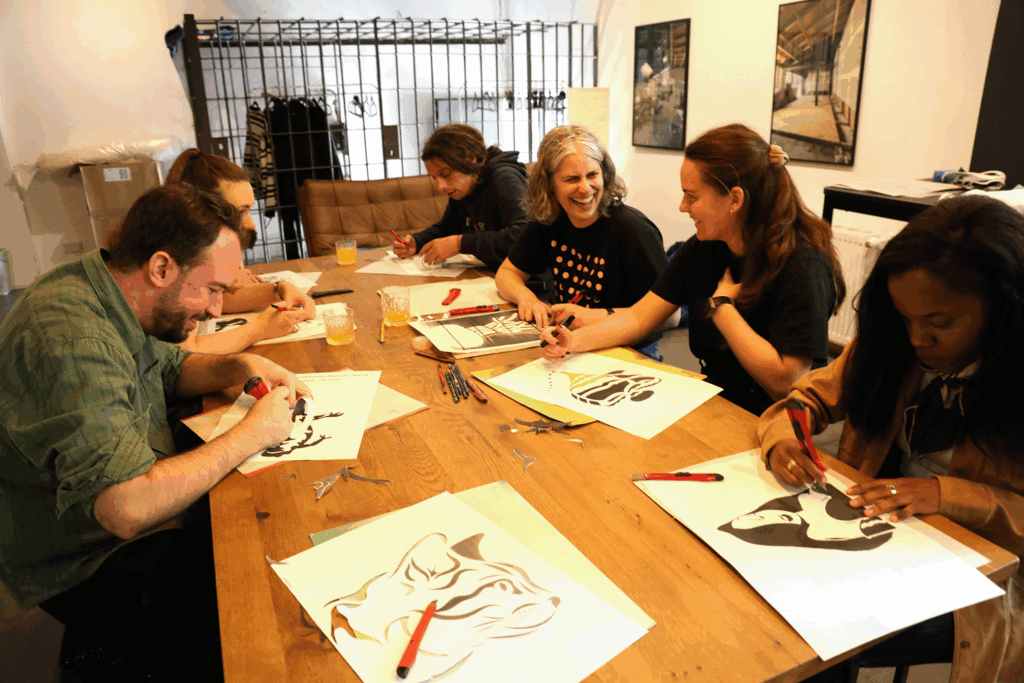 Some of the Centre team around a table creating stencils at a team workshop in Berlin