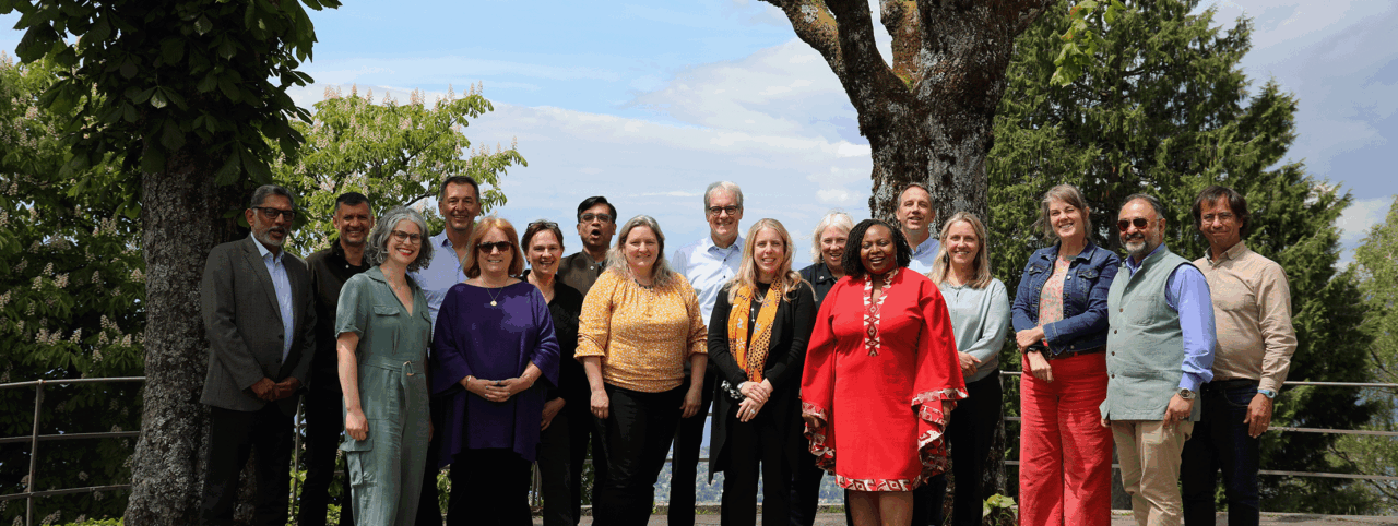 Group photo of CEOs at Vision works 2025, standing outside in front of trees in Caux, Switzerland